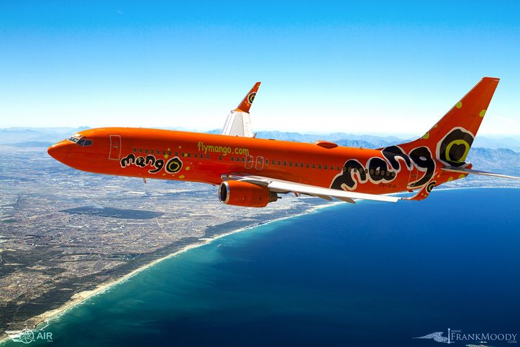 Mango Boeing 737 flying over False Bay, air-to-air photograph by Frank Moody