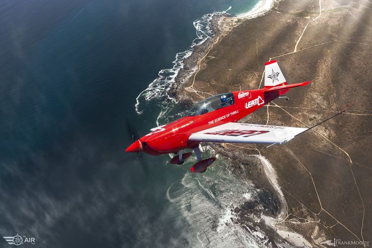 Marksmen Aerobatic Team aircraft banking over the Cape coastline, air-to-air photograph by Frank Moody