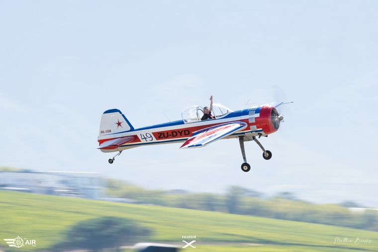 Yak aerobatic aircraft ZU-DYD climbing away from the runway, photograph by Matthew Brooks