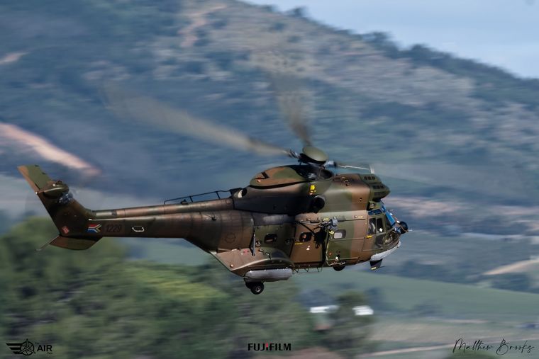 South African Air Force Oryx helicopter flying past a hillside, photograph by Matthew Brooks